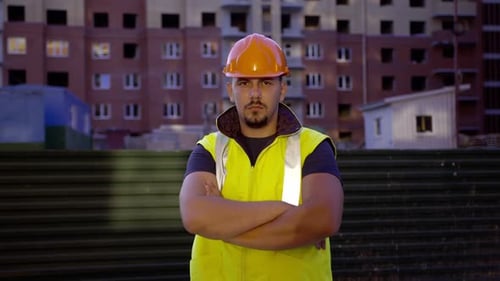 Un homme sérieux en uniforme regarde la caméra