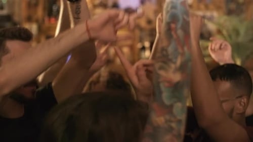 Friends Cheering at Nighttime Indoor Venue