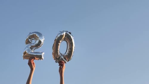 Silver 2022 Balloons Raised to the Sky