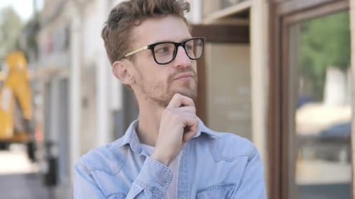 Pensive Young Adult Man Considering Outdoors