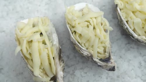 Oysters Topped with Shredded Cheese Ready to Cook
