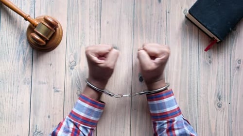 Hands of a Man with Handcuffs Close Up.
