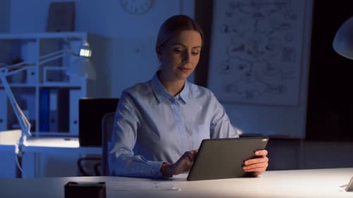 Businesswoman with Tablet Working at Night Office