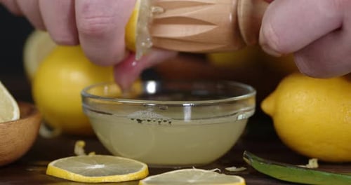Lemon Being Squeezed With A Wooden Squeezer