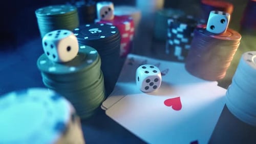 Casino Chips with Dice and Playing Cards on a Dark Table