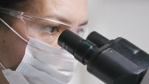 Scientist Looking into Microscope