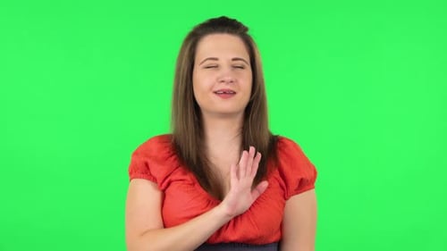 Woman in Orange Communicating With Hand Gestures