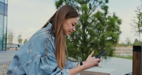 Woman Using Smartphone in Urban Outdoor Setting