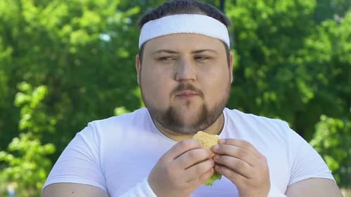 Fat Man Eating Burger After Workout, Addicted to Junk Food, Lack of Willpower