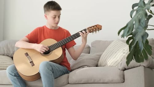 Teen Plays Classical Guitar at Home
