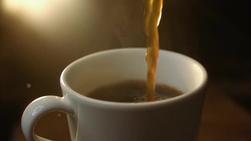 Pouring Hot Coffee in Mug Close Up