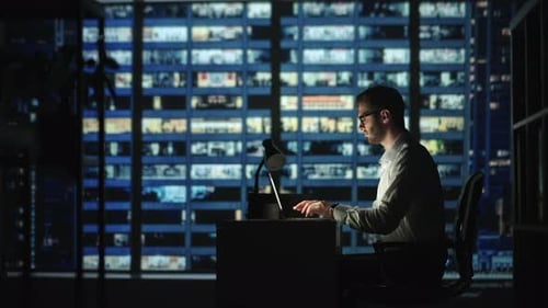 Portrait of Thoughtful Successful Businessman Working on Laptop Computer in His Big City Office at