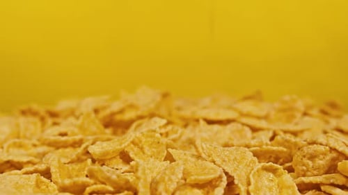Cornflakes Topple on Yellow Background