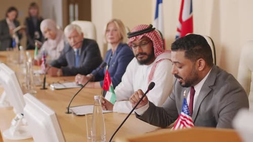 Meeting of Adults with Microphones and Flags