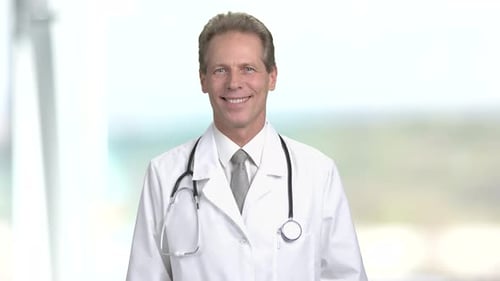 Smiling Mature Doctor in White Coat