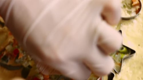 Filling Christmas Cookie Cutters With Savory Food Mixture