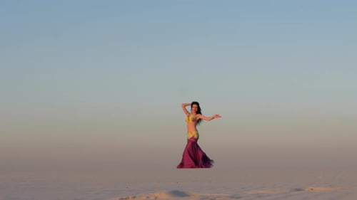 Woman Belly Dancing in Desert at Sunrise