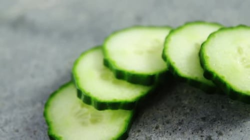 Sliced cucumber on concrete