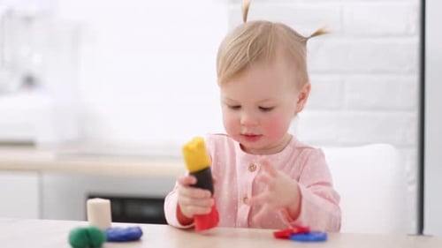Infant Building Tower With Plasticine