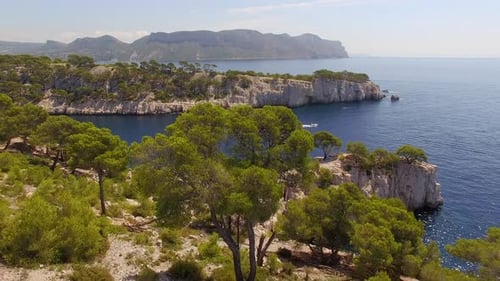 Aerial travel drone view of clear green water, cliffs of Cassis, Mediterranean Sea, Southern France.