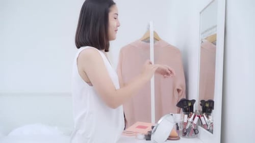 Woman Applying Makeup in Bright, Clean Home Setting