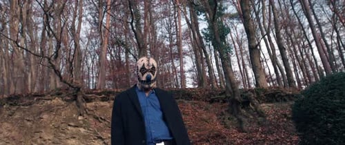 Man in Mask Standing Still in Forest