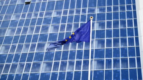 European Union Flag Waving in Front of Building