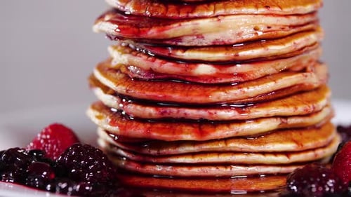 Stacked Pancakes with Fresh Berries and Syrup