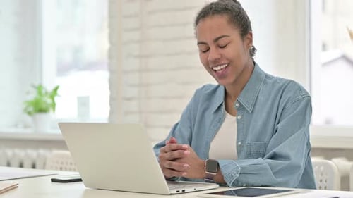 Woman in Video Call on Laptop in Office