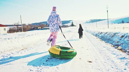 Children Enjoying a Sunny Winter Day with Snow