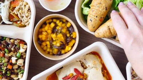 Woman Hand Putting Organic Carrot Bread on Green Salad Healthy Food Concept
