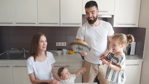 Family Makes Pancakes Together in Bright Kitchen