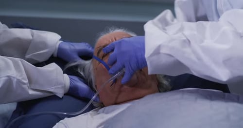 Medical Staff Attending to Patient in Hospital Bed
