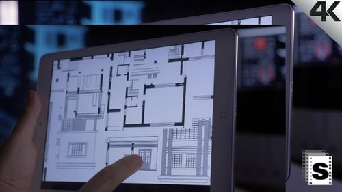 Hands Using Tablet with House Blueprints