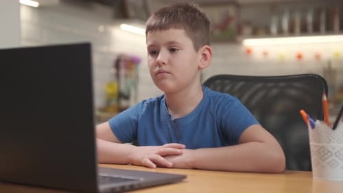 Boy Using Laptop Computer for Online Learning