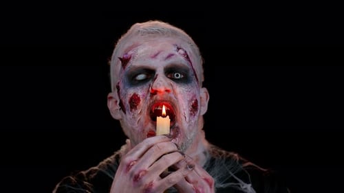 Man with Zombie Makeup Holding Burning Candle