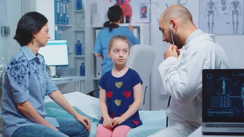 Doctor Examining Child with Stethoscope in Clinic