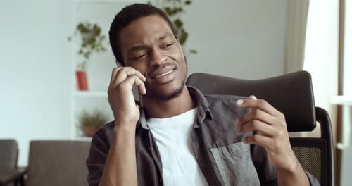 Man Talking on Cellphone at Home