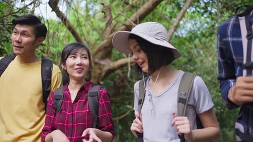Group of young Asian man and woman friend backpacker traveling and walk in the forest together.
