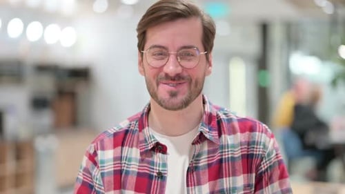 Man Waving and Talking on Video Conference