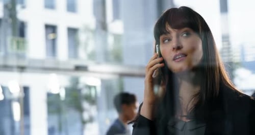 Business Woman Talking on Phone in Modern Office