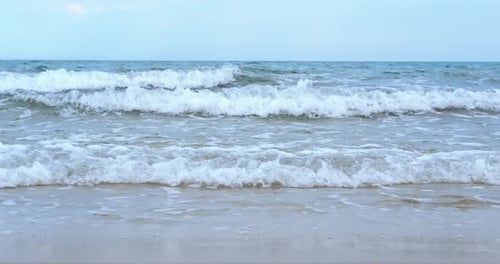 Waves Crashing on the Beach on a Sunny Day