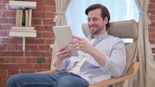 Adult Man Video Chatting on Tablet Indoors