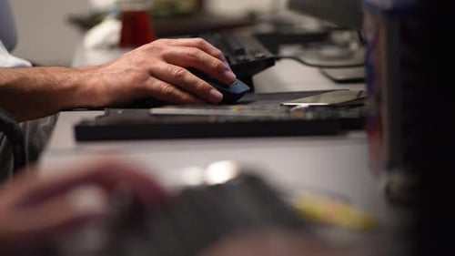 Hands Using Computer Mouse and Keyboard in Office