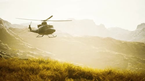 Slow Motion Vietnam War Era Helicopter in Mountains