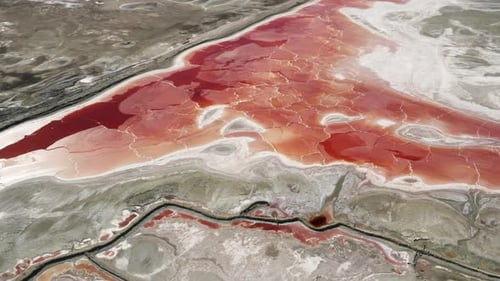Aerial Drone View to Old Salt Mining Mineral Lake with Pink Orange and Red Water