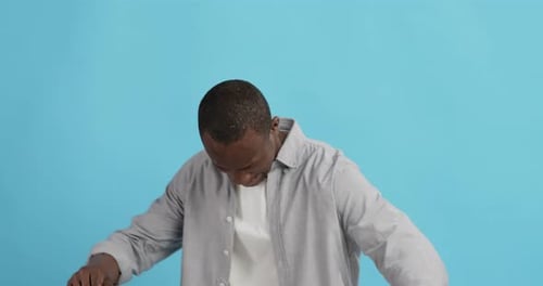 Positive African American Guy Dancing, Blue Studio Background