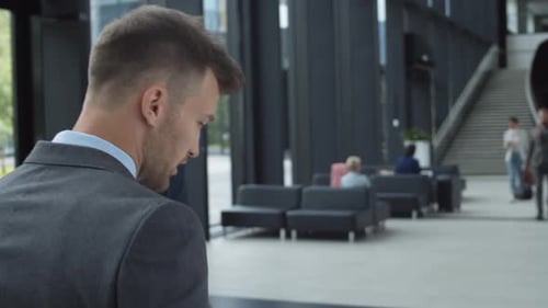 Businessman Having Telephone Conversation in Airport