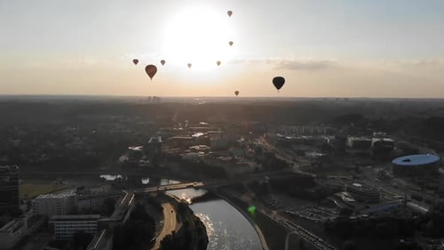 Flying Up and Revealing a Silhouettes of Hot Air Balloons Flying Over Beautiful Green Park in Vilniu