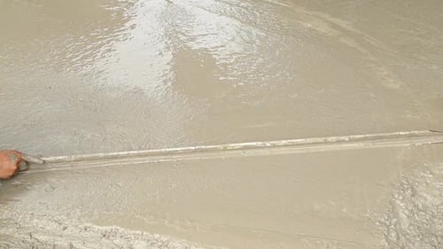 wood trowel working to smooth concrete ground